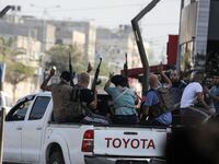 Palestinian militants of the Ezzedine al-Qassam Brigades move towards the Erez crossing between Israel and the northern Gaza Strip on October 7, 2023..
