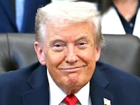 US President Donald Trump smiles during an announcement in the Oval Office of the White House in Washington, DC, on October 16, 2025.