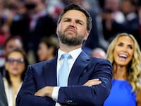 Republican vice presidential nominee J.D. Vance, with RNC co-chair Lara Trump behind him, looks at the stage during Day 1 of the Republican National Convention (RNC), at the Fiserv Forum in Milwaukee, Wisconsin, U.S., July 15, 2024.