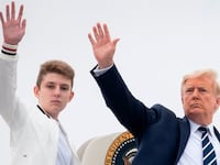 U.S. President Donald Trump and his son Barron wave as they board Air Force One.