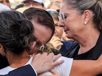 Israel's President Isaac Herzog and his wife Michal Herzog embrace Rachel Goldberg