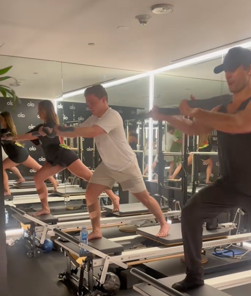 Jake Shane struggles and shakes as he works out with actor Glen Powell in a TikTok video he posted in 2024.