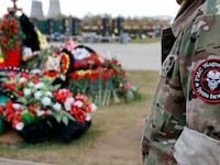 A man visits the grave of Dmitry Utkin, a commander of the Wagner mercenary group, while marking 40 days since Utkin and the group's chief Yevgeny Prigozhin's death at a cemetery in Mytishchi on the outskirts of Moscow, Russia,