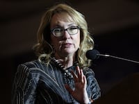 Gabby Giffords, former U.S. Representative and wife of Sen. Mark Kelly (D-AZ) introduces her husband at a campaign event at Cesar Chavez High School on Nov. 2, 2022, in Phoenix, Arizona.