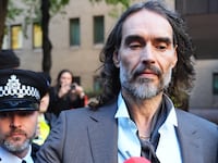 Russell Brand is leaving Southwark Crown Court, London, on October 27, 2026, where he faces three charges of rape, indecent assault, and three counts of sexual assault relating to six women.