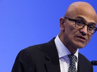 Satya Nadella speaks on stage at a summit in San Francisco.