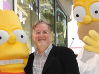 Matt Groening, creator of "The Simpsons," poses with his characters Bart (L) and Homer Simpson