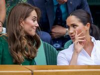 Catherine, Duchess of Cambridge talks with Meghan, Duchess of Sussex in 2019