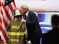 Former president Donald Trump kisses the fire gear belonging to Corey Comperatore on the final night of the Republican National Convention at Fiserv Forum on July 18, 2024 in Milwaukee, Wisconsin.
