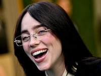 Billie Eilish laughs at the People's Choice Awards.