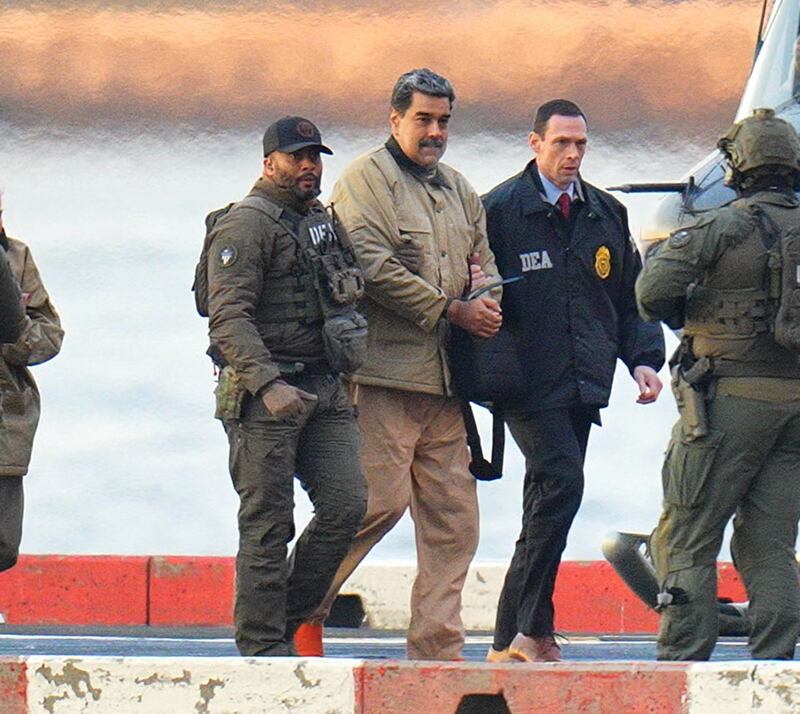 Nicolas Maduro is seen in handcuffs after landing at a Manhattan helipad, escorted by heavily armed Federal agents as they make their way into an armored car en route to a Federal courthouse in Manhattan on January 5, 2026 in New York City.