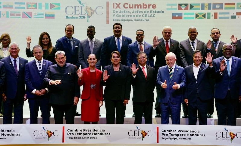 World leaders pose next to other representatives for the family photo of the IX Latin American and Caribbean States (CELAC) Summit, at the Central Bank of Honduras (BCH) in Tegucigalpa on April 9, 2025.