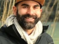 A photo of a smiling Ryan Furtado, wearing a baseball cap.