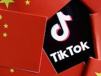 China’s flags are seen near a TikTok logo in this illustration picture taken July 16, 2020.