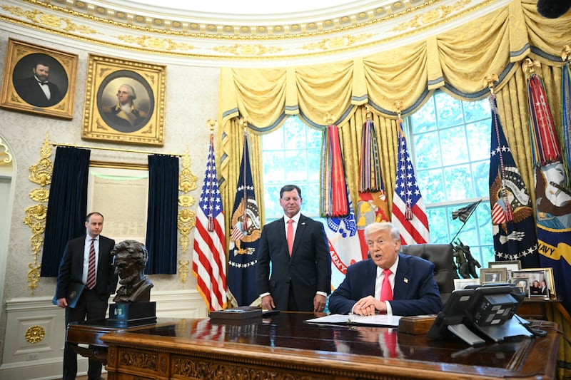 President Donald Trump spoke in the Oval Office on August 14, 2025 as Social Security Administration Commissioner Frank Bisignano and Staff Secretary Will Scharf looked on.