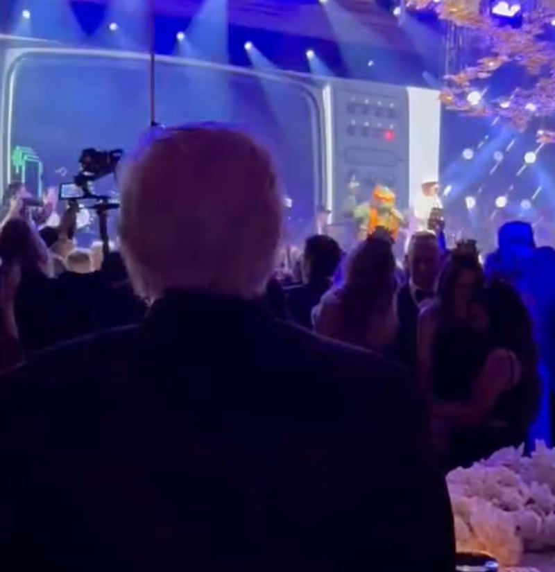 President Donald Trump, left, bobbed side to side as the Teenage Mutant Turtle named Michaelangelo danced on stage at Mar-a-Lago.