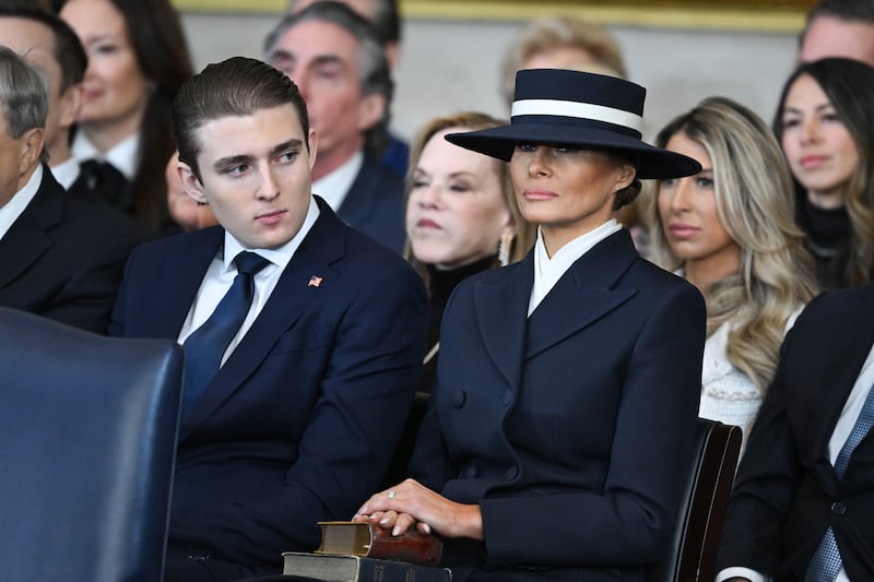 Barron Trump and first lady Melania Trump listen as President Donald Trump gives his inaugural address in the U.S. Capitol Rotunda on January 20, 2025