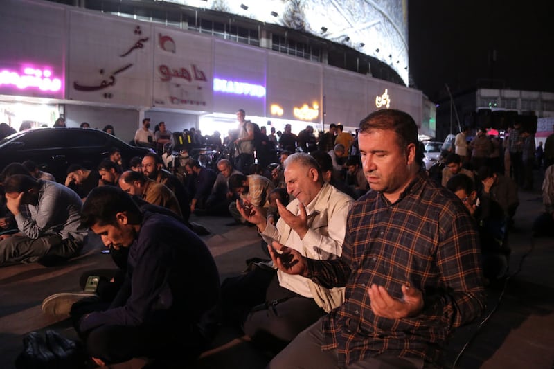 Iranians pray for the President Ebrahim Raisi and his delegation following a helicopter crash.