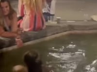 A tourist swims topless in a Florence fountain