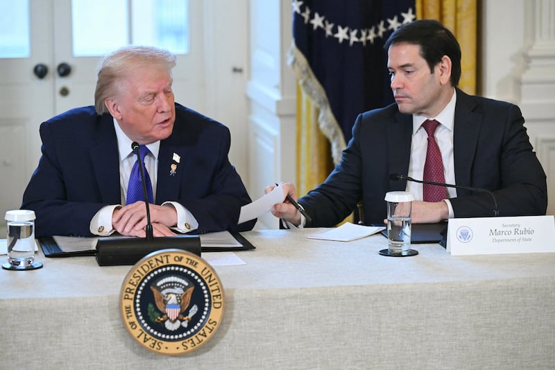 US Secretary of State Marco Rubio (R) hands a note to US President Donald Trump during a meeting with US oil companies executives in the East Room of the White House in Washington, DC on January 9, 2026. President Trump is aiming to convince oil executives to support his plans in Venezuela, a country whose energy resources he says he expects to control for years to come. US forces seized Venezuelan president Nicolas Maduro in a sweeping military operation on January 3, with Trump making no secret that control of Venezuela's oil was at the heart of his actions. (Photo by SAUL LOEB / AFP via Getty Images)