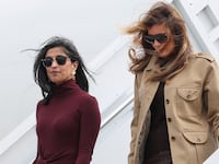 RICHLANDS, NORTH CAROLINA - NOVEMBER 19: Second lady Usha Vance (L) and first lady Melania Trump depart a plane as they arrive at Albert J. Ellis Airport en route to Camp Lejeune on November 19, 2025 in Richlands, North Carolina. Trump and Vance are traveling together for the day to visit military families and schools at Marine Corps Base Camp Lejeune. (Photo by Anna Moneymaker/Getty Images)