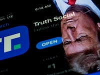 This photo illustration shows an image of former President Donald Trump reflected in a phone screen that is displaying the Truth Social app.