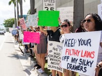 An abortion rights activist holds a sign at a protest in support of abortion access