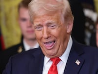 Donald Trump to a large ring during a presentation ceremony for the Commander-in-Chief Trophy.
