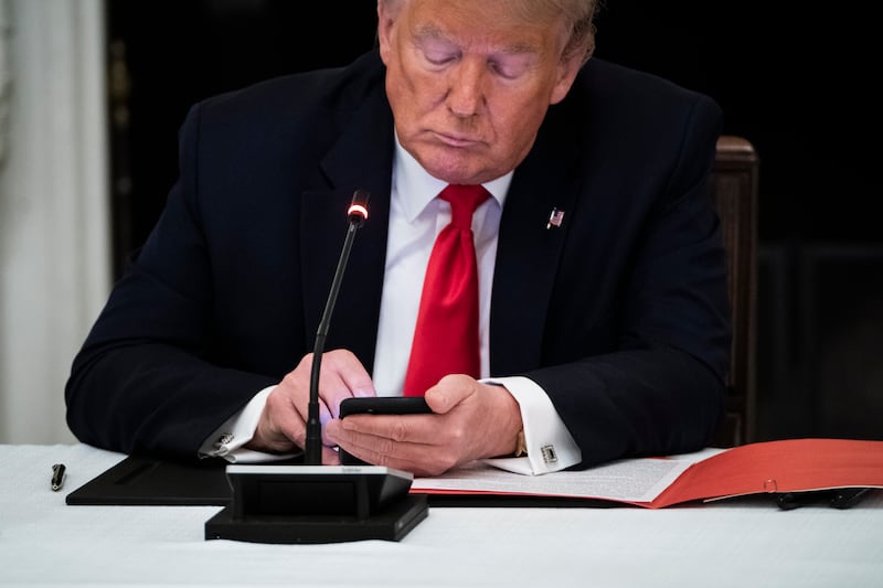President Donald J. Trump uses his cellphone in the State Dinning Room at the White House on Thursday, June 18, 2020 in Washington, DC.