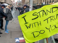 A woman protesting in support of former president Donald J. Trump is detained by court officers for getting in to an altercation with a pedestrian and brandishing a knife outside the District Attorney's office, in New York City.
