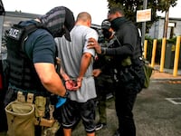 Immigration and Customs Enforcement agents apprehend an an illegal immigrant