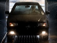 A new car is washed in a Venirauto car manufacturing plant