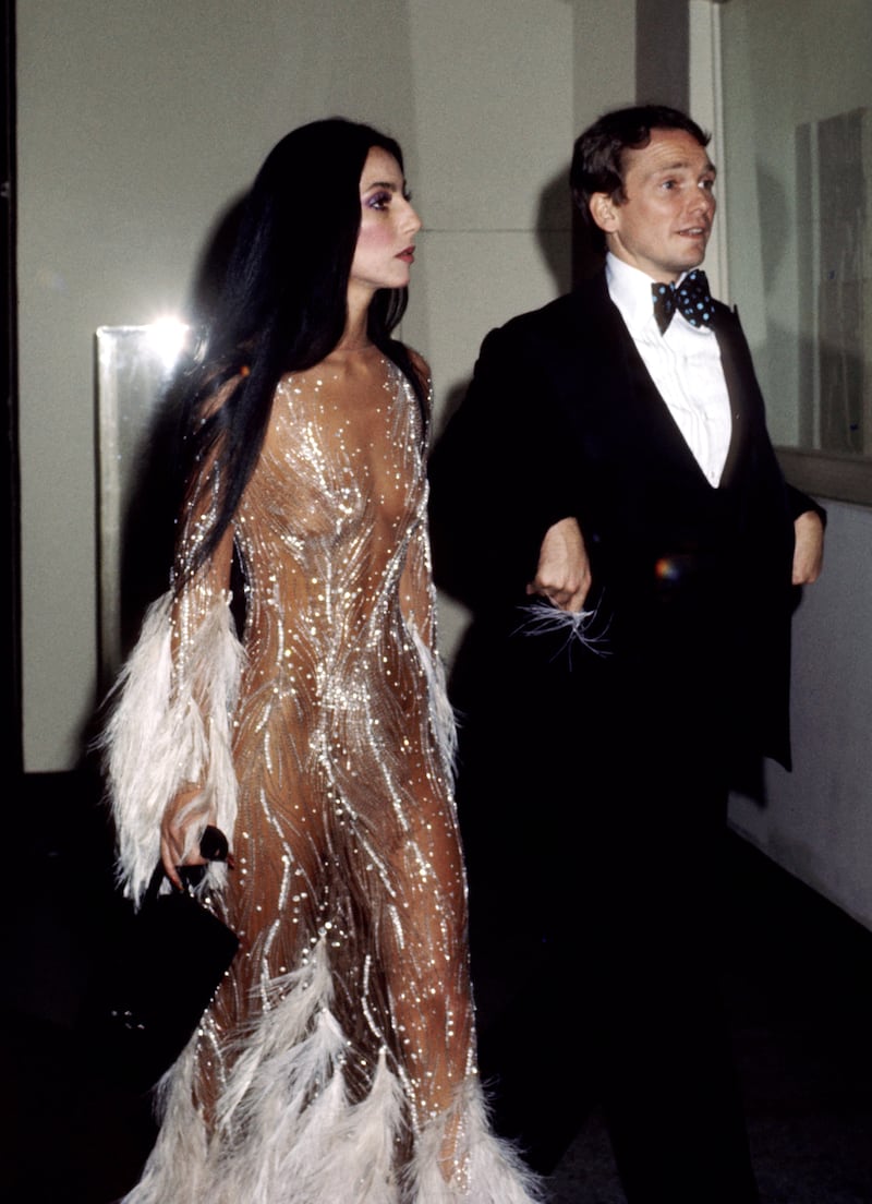 Cher revealed that her iconic "naked dress" was made from illegal fabric.