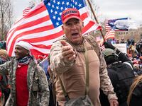 Ray Epps, in the red Trump hat, center, gestures to others as people gather on the West Front of the U.S. Capitol on Jan. 6, 2021.