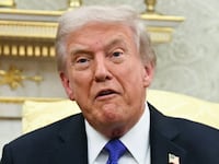US President Donald Trump shows the floor plan of his planned ballroom.