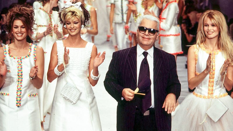 Cindy Crawford, Linda Evangelista, and Claudia Schiffer walk the runway at the Chanel Ready-to-Wear Spring/Summer 1996 fashion show, with designer Karl Lagerfeld, during Paris Fashion Week in 1995.