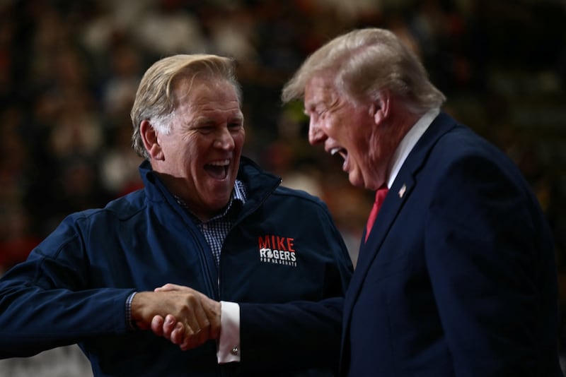 President Donald Trump shakes hands with Republican senatorial candidate for Michigan Mike Rogers during a campaign rally at the McMorran Place Sports & Entertainment Center in Port Huron, Michigan, on October 25, 2026.