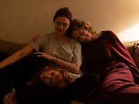 A photo still of Natasha Lyonne, Elizabeth Olsen, and Carrie Coon in 'His Three Daughters'