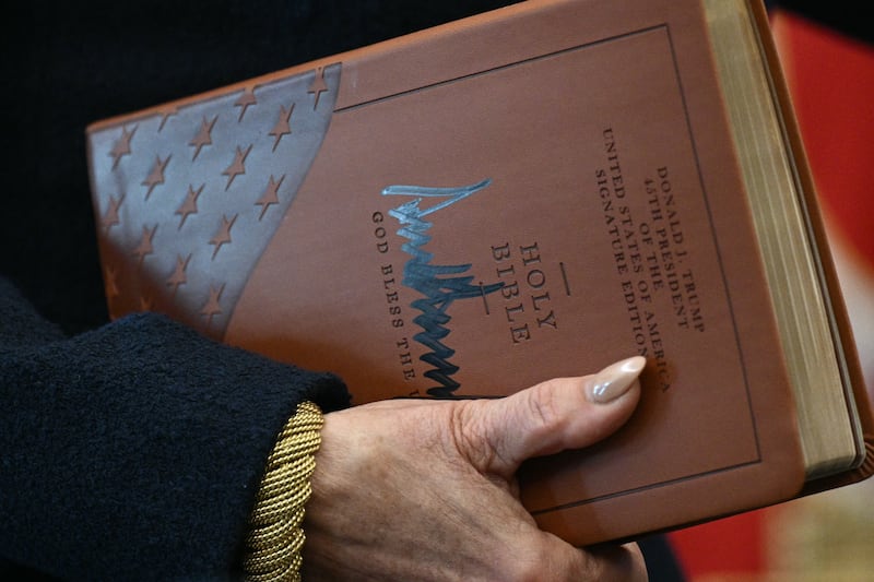 US Attorney for the District of Columbia Jeanine Pirro holds the Holy Bible signed by Trump before Gor's swearing-in.