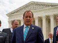 Texas Attorney General Ken Paxton leaves a news conference.