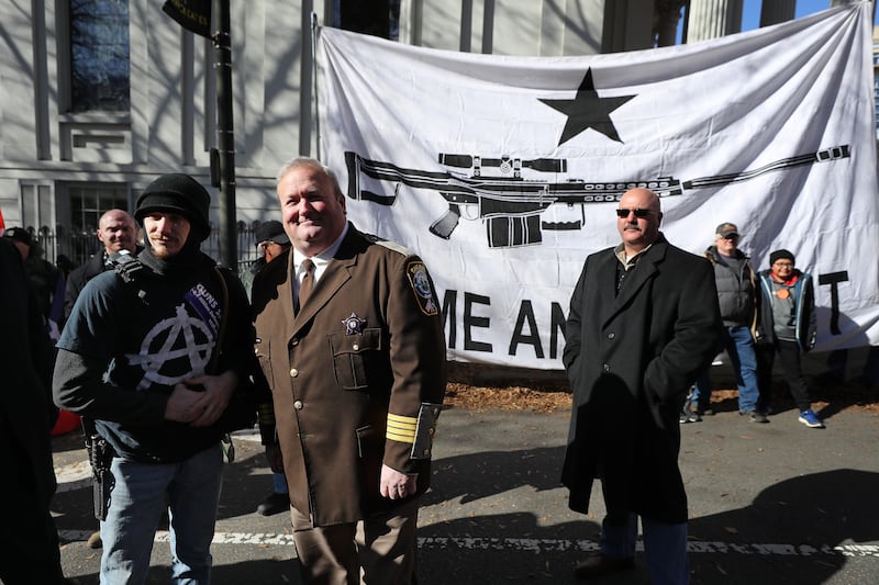 RICHMOND, VIRGINIA - JANUARY 20: Culpeper County, Virginia, Sheriff Scott Jenkins poses for photographs following a gun rights rally organized by The Virginia Citizens Defense League near the State Capitol Building January 20, 2020 in Richmond, Virginia. Jenkins has promised to deputize thousands of his county's gun owners if Democrats pass more restrictive gun laws. During elections last year, Virginia Governor Ralph Northam promised to enact sweeping gun control laws in 2020, including limiting handgun purchase to one per month, banning military-style weapons and silencers, allowing localities to ban guns in public spaces and enacting a 'red flag' law so authorities can temporarily seize weapons from someone deemed a threat. While event organizers have asked supporters to show up un-armed, militias and other extremist groups from across the country plan to attend the rally and show their support for gun rights. (Photo by Chip Somodevilla/Getty Images)