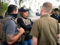 Homeland Security Secretary Kristi Noem has accompanied ICE agents on numerous raids this year. Oftentimes, she is the only official who is not concealing their identity with a neck gaiter or mask.