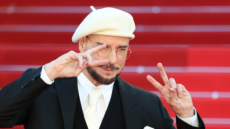 John Travolta attends the "Karma" screening in a white beret during the 79th annual Cannes Film Festival in 2026.