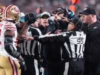 San Francisco 49ers linebacker Dre Greenlaw (57) has an altercation with Philadelphia Eagles staff member Dom DiSandro