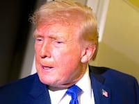 President Donald Trump speaks to members of the media aboard Air Force One while flying from Palm Beach International Airport on February 16, 2026.