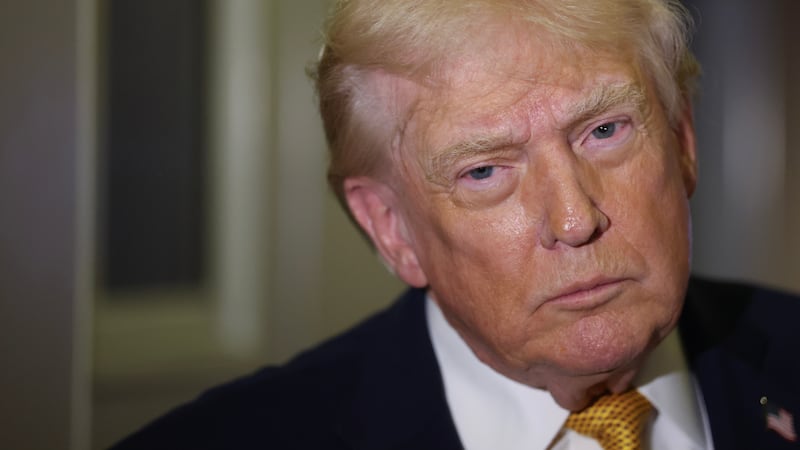 President Donald Trump speaks to the media aboard Air Force One en route to Washington, DC on January 04, 2026.