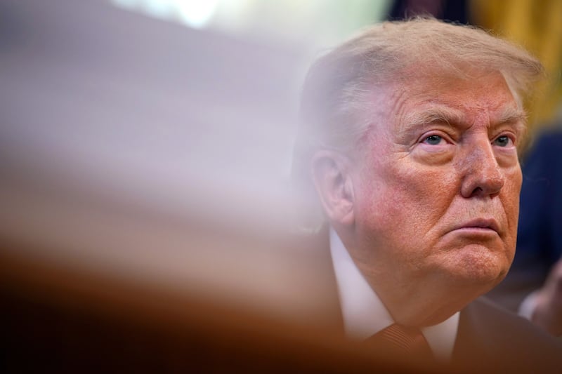 Trump looks on during an event in the Oval Office in Washington, DC, on October 20, 2026.