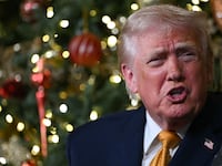 US President Donald Trump participates in NORAD Santa tracker phone calls, on Christmas Eve, from the Mar-a-lago club in Palm Beach, Florida, on December 24, 2025. (Photo by ANDREW CABALLERO-REYNOLDS / AFP via Getty Images)