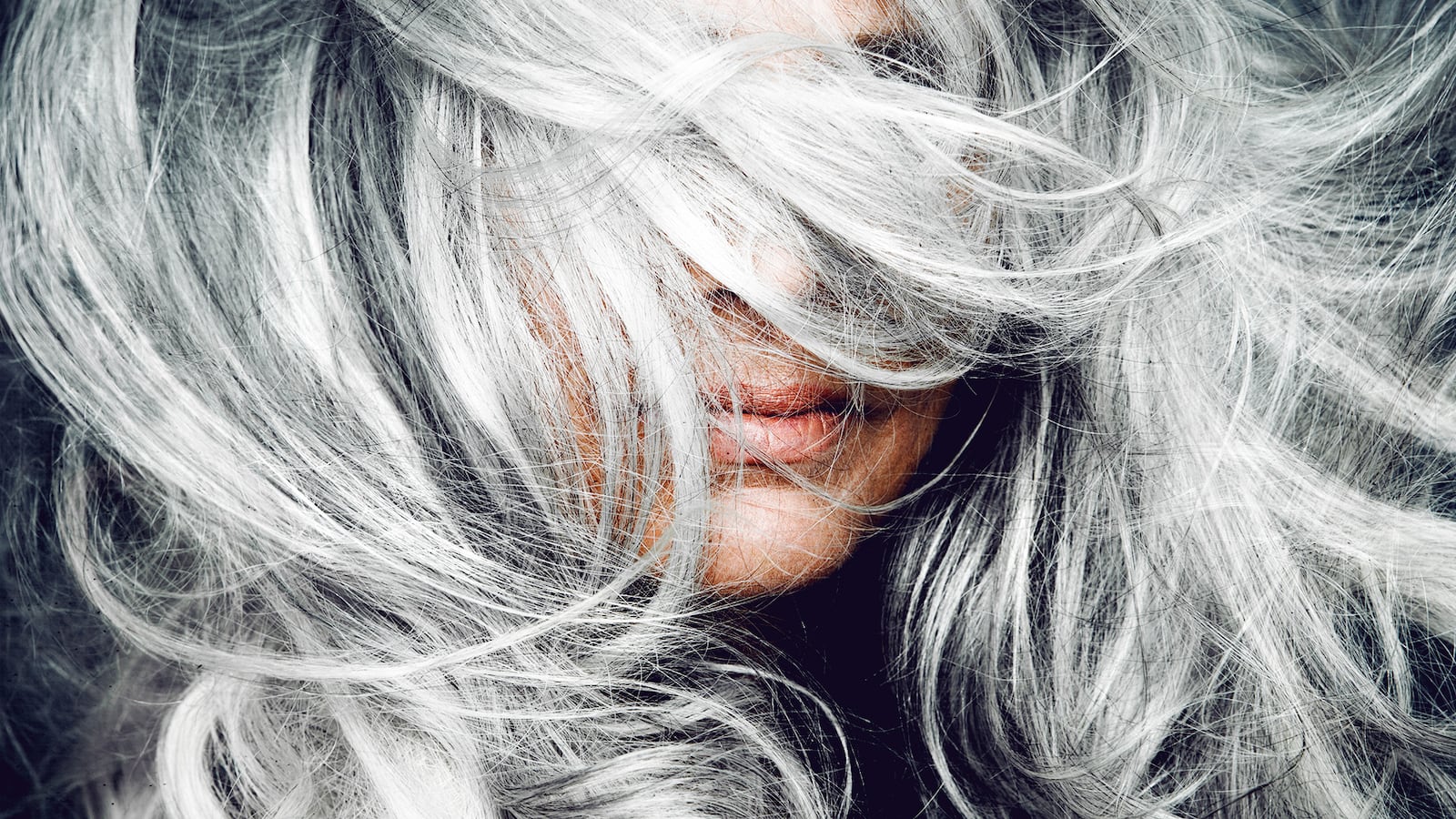 Woman tossing her silver hair.
