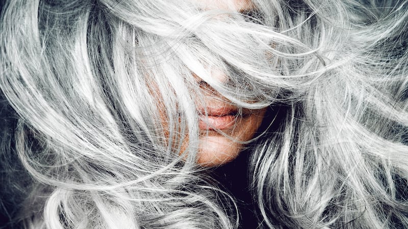 Woman tossing her silver hair.